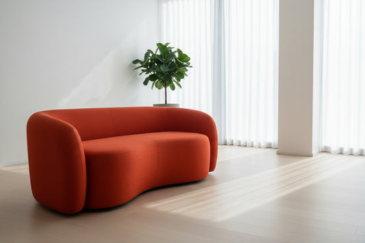 Modern curved couch in a bold burnt-orange fabric